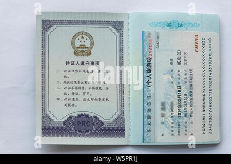 A police officer shows the passport-shaped travel pass for use between the Chinese mainland and Hong Kong or Macao in Beijing, China, 6 May 2019.   Th Stock Photo