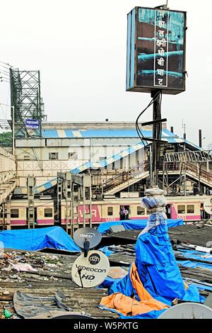 Mahalaxmi Railway Station foot overbridge and slums Mumbai Maharashtra India Asia Stock Photo