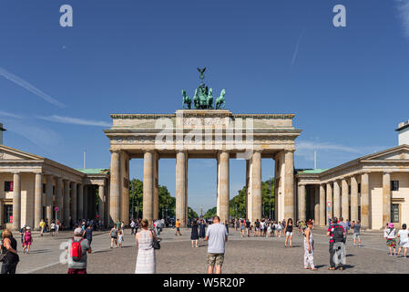 2019-24-07 Berlin, Germany: groups of tourists at Pariser Platz looking at Brandenburg Gate on sunny summer day Stock Photo