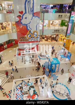 Customers visit an exhibition held to mark the 60th anniversary of iconic Chinese candy brand White Rabbit at a shopping mall in Guangzhou city, south Stock Photo