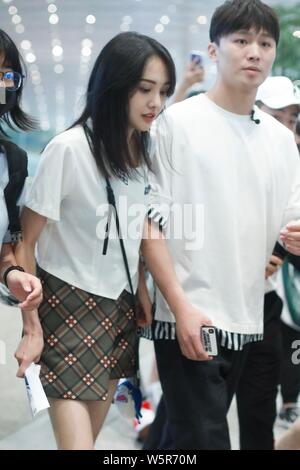 Chinese actress Zheng Shuang, left, and her boyfriend arrive at the Beijing Capital International Airport in Beijing, China, 20 June 2019. Stock Photo