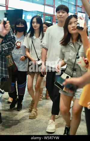 Chinese actress Zheng Shuang, left, and her boyfriend arrive at the Beijing Capital International Airport in Beijing, China, 20 June 2019. Stock Photo