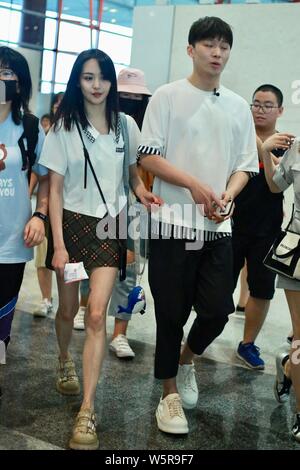 Chinese actress Zheng Shuang, left, and her boyfriend arrive at the Beijing Capital International Airport in Beijing, China, 20 June 2019. Stock Photo