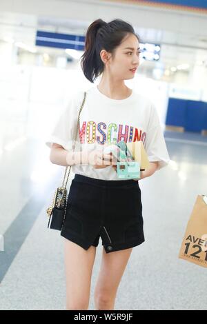 Chinese actress Yukee Chen or Chen Yuqi arrives at the Beijing Capital International Airport before departure in Beijing, China, 30 May 2019.   T-shir Stock Photo