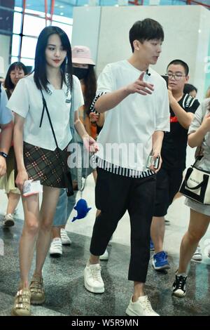 Chinese actress Zheng Shuang, left, and her boyfriend arrive at the Beijing Capital International Airport in Beijing, China, 20 June 2019. Stock Photo