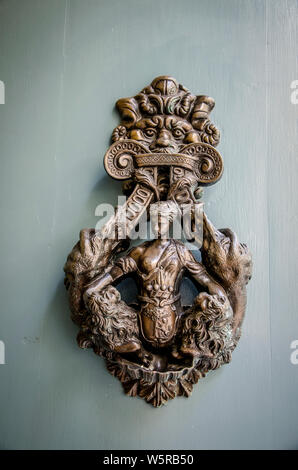 A decorative brass door knob in the form of a sculptured womans body. Typical of Malta Stock Photo