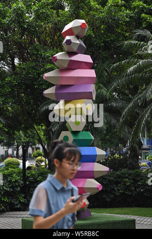 A colored pencil installation is on display at a square amongst office  buildings in Guangzhou city, south China's Guangdong province, 23 June  2019. A square amongst a cluster of high-rise office buildings