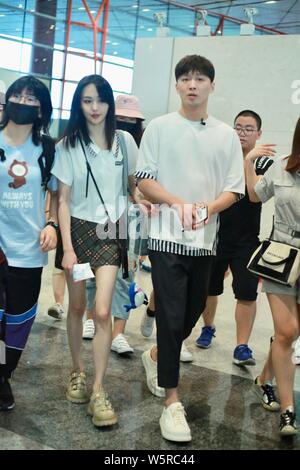 Chinese actress Zheng Shuang, left, and her boyfriend arrive at the Beijing Capital International Airport in Beijing, China, 20 June 2019. Stock Photo