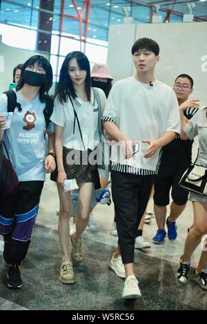 Chinese actress Zheng Shuang, left, and her boyfriend arrive at the Beijing Capital International Airport in Beijing, China, 20 June 2019. Stock Photo