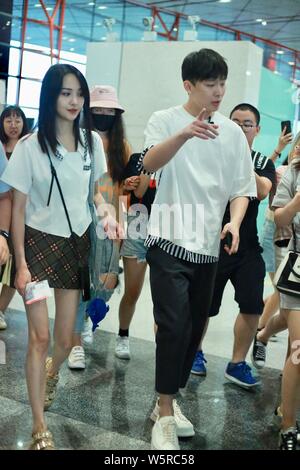 Chinese actress Zheng Shuang, left, and her boyfriend arrive at the Beijing Capital International Airport in Beijing, China, 20 June 2019. Stock Photo