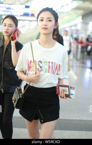 Chinese actress Yukee Chen or Chen Yuqi arrives at the Beijing Capital International Airport before departure in Beijing, China, 30 May 2019.   T-shir Stock Photo