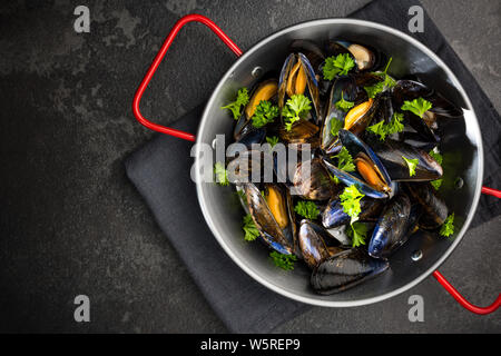 Mussels with Fresh Parsley, Seafood Dish, Top View. Stock Photo