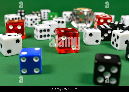 Multiple colored dice in close up view , placed on a green surface Stock Photo