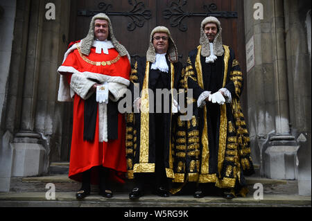 Robert Buckland QC (centre) poses for a photo with the Lord Chief Justice, Lord Burnett of Maldon (left) and Master of the Rolls Sir Terence Etherton (right), as he arrives at the Royal Courts of Justice in London for his swearing in ceremony as Lord Chancellor. Stock Photo