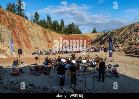 Lydbrook Brass Band play a 'Proms in the Quarry' at Barnhill Quarry, Forest of Dean, Gloucestershire. Event includes flypast to 'The Dambusters' Stock Photo