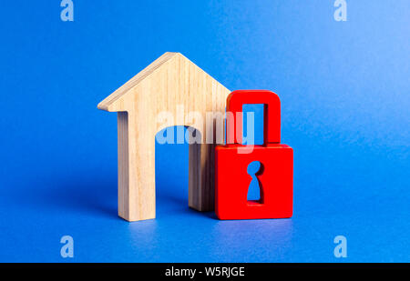 House figurine with large doorway and red padlock. Security and safety. Confiscation for debts. alarm system. seizure of property. Protection of prope Stock Photo