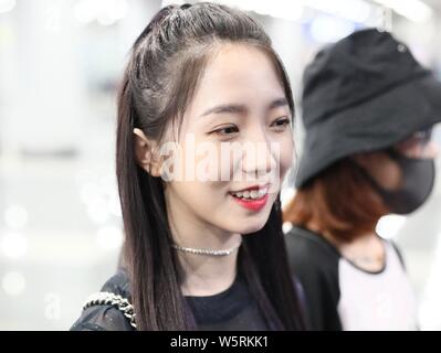 Meng Meiqi of Chinese idol girl group Rocket Girls 101 arrives at the Beijing Capital International Airport in Beijing, China, 3 June 2019.   Handbag: Stock Photo