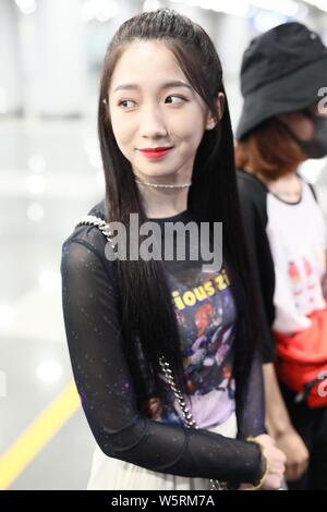 Meng Meiqi of Chinese idol girl group Rocket Girls 101 arrives at the Beijing Capital International Airport in Beijing, China, 3 June 2019.   Handbag: Stock Photo