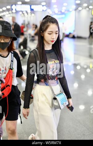Meng Meiqi of Chinese idol girl group Rocket Girls 101 arrives at the Beijing Capital International Airport in Beijing, China, 3 June 2019.   Handbag: Stock Photo