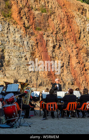 Lydbrook Brass Band play a 'Proms in the Quarry' at Barnhill Quarry, Forest of Dean, Gloucestershire. Event includes flypast to 'The Dambusters' Stock Photo