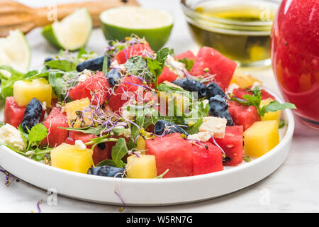Serving Summer Fresh Watermelon Salad with Fresh Mint and Lime Juice. Stock Photo