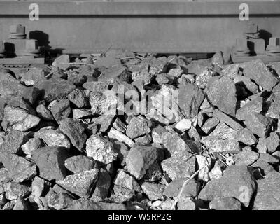 Detail of railroad track with gravel and rail in black and white Stock Photo