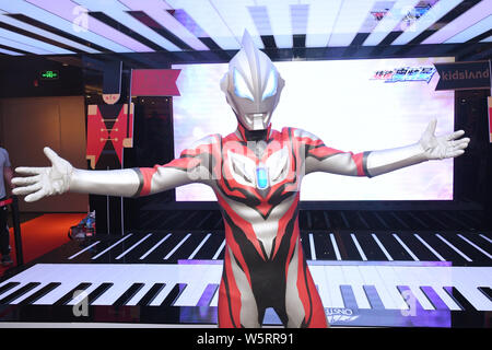 A Chinese worker dresses up as Ultraman Geed from Japanese tokusatsu television series to celebrate the International Children's Day at a shopping mal Stock Photo