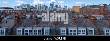 A dramatic panoramic view of London's square mile seen from Whitechapel and containing local buildings and the main skyscrapers of the City of London Stock Photo