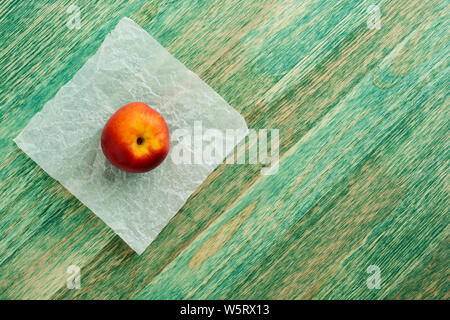 Fresh ripe nectarines on green rustic wooden background. Top view with copy space. Flat lay. Stock Photo