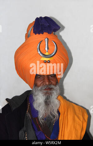 Close-up photo of An indian senior aged male farmer standing in field ...