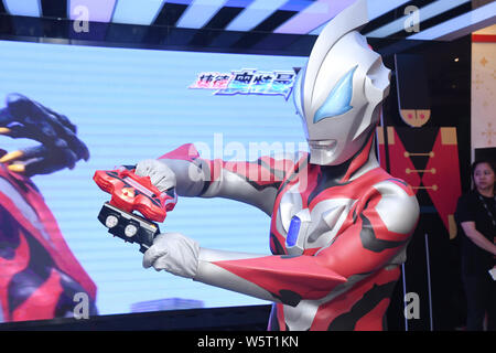 A Chinese worker dresses up as Ultraman Geed from Japanese tokusatsu television series to celebrate the International Children's Day at a shopping mal Stock Photo