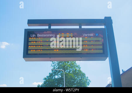 Information panel with Dutch bus departure times,electronic bulletin ...