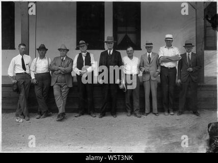 Officials of Bureau and Six Cos., Inc., with first Assistant Secretary of the Interior Theodore F. Walters at Boulder City. Left to right: John C. Page, Office Engineer, Bureau of Reclamation; W.A. Bechtel, President, Six Cos., Inc.; Theodore A. Walters; C.F. Shea, Director of Construction, Six Cos., Inc.; Sims, City Manager, Boulder City; Frank T. Crowe, Gen. Supt., Six Cos., Inc.; Walker R. Young, Construction Engineer, Bureau of Reclamation.; Scope and content:  Photograph from Volume Two of a series of photo albums documenting the construction of Hoover Dam, Boulder City, Nevada. Stock Photo
