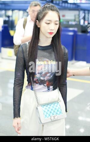 Meng Meiqi of Chinese idol girl group Rocket Girls 101 arrives at the Beijing Capital International Airport in Beijing, China, 3 June 2019.   Handbag: Stock Photo