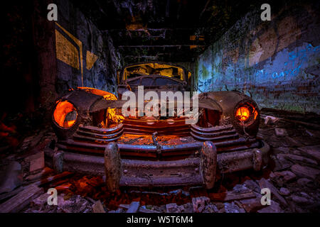 Long exposure with flashlights. Abandoned old car illuminated with flashlights Stock Photo