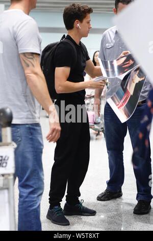 English actor and dancer Tom Holland signs autographs for fans as