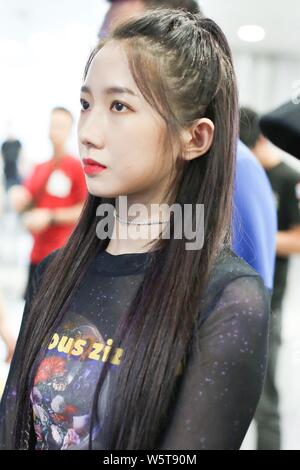 Meng Meiqi of Chinese idol girl group Rocket Girls 101 arrives at the Beijing Capital International Airport in Beijing, China, 3 June 2019.   Handbag: Stock Photo