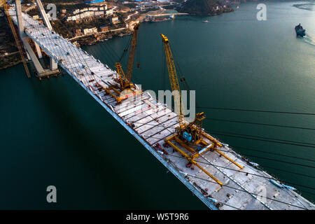 Aerial view of the last bridge deck of the Xiangxi Yangtze River Bridge being installed in Zigui county, Yichang city, central China's Hubei province, Stock Photo