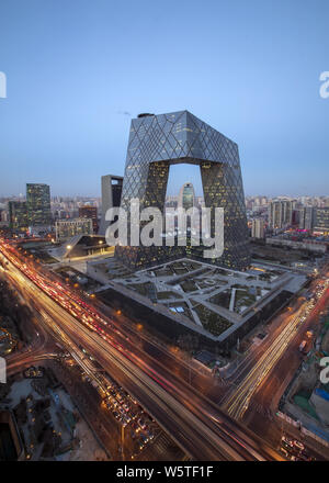 A night view of busy roads with masses of vehicles in front of the new CCTV Tower in the Central Business District (CBD) in Beijing, China, 27 Decembe Stock Photo