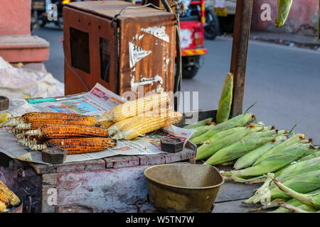 Grilled corn cobs at a kiosk of a street vendor in Jaipur, India Stock Photo