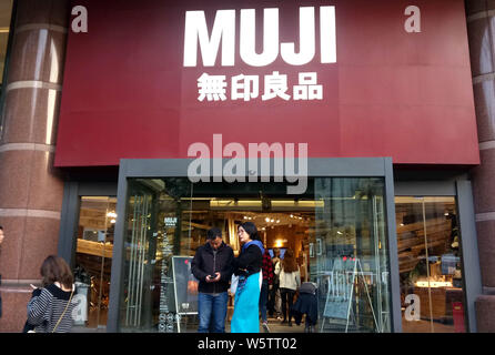 --FILE--Pedestrians walk past a store of Muji in Shanghai, China, 9 November 2018.   Ryohin Keikaku, the company that runs the Muji chain of household Stock Photo