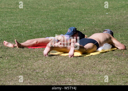 23/07/2019. Battersea, London, UK. People sunbath in Battersea Park in London during a heatwave across the UK. Stock Photo