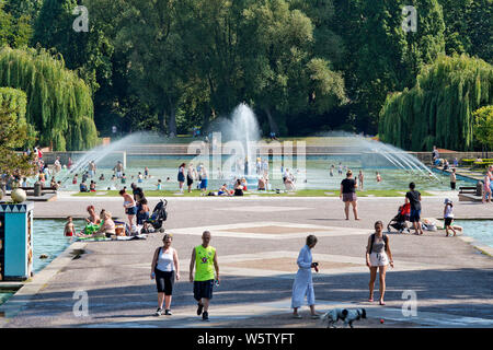 23/07/2019. Battersea, London, UK. People play in the water fountains in Battersea Park in London during a heatwave across the UK. Stock Photo