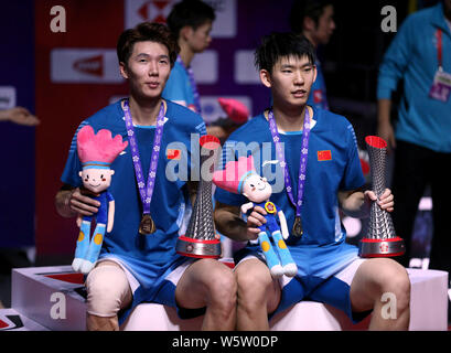 Li Junhui and Liu Yuchen of China pose with their trophies after defeating Hiroyuki Endo and Yuta Watanabe of Japan in their Men's Doubles final match Stock Photo