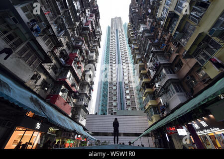 View of the Monster Building (Yik Cheong Building), one of Hong Kong's most Instragrammable sites, known for its incredibly dense and stacked flats, i Stock Photo