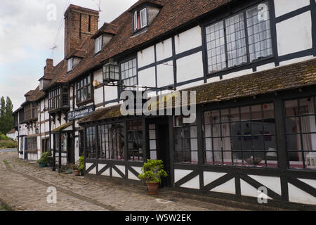 Original 1400s and Tudor buildings and pavement along Biddenden high street in Kent England Stock Photo