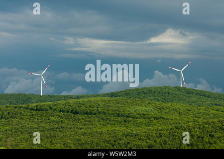 Wind turbines in forest hills Stock Photo
