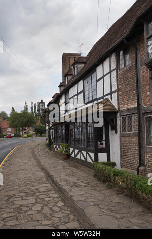 Original 1400s and Tudor buildings and pavement along Biddenden high street in Kent England Stock Photo