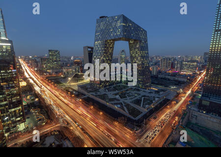 A night view of busy roads with masses of vehicles in front of the new CCTV Tower in the Central Business District (CBD) in Beijing, China, 27 Decembe Stock Photo