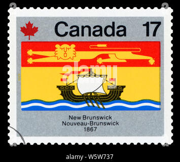 CANADA - CIRCA 1979: A stamp printed in Canada from the 'Canada Day. Flags' issue shows New Brunswick flag, circa 1979. Stock Photo
